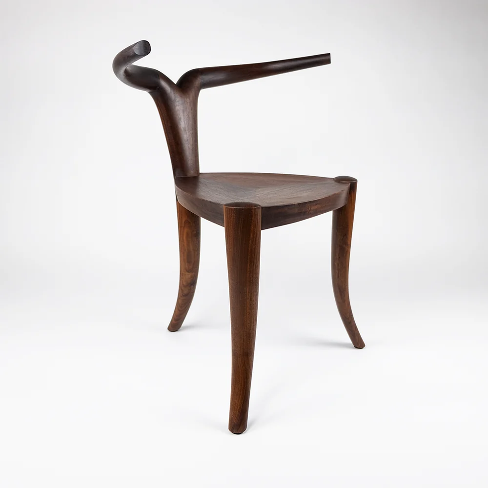If This. Then That: Chairs – Pierre Jeanneret → Jomo Tariku 3 Jomo Tariku Nyala chair, three-quarter view showing carved horn-shaped arms and splayed legs