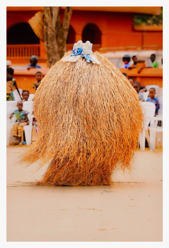 A raffia Zangbeto masquerade spinning in the square before the temple at the Festival des Masques in Porto-Novo, Benin