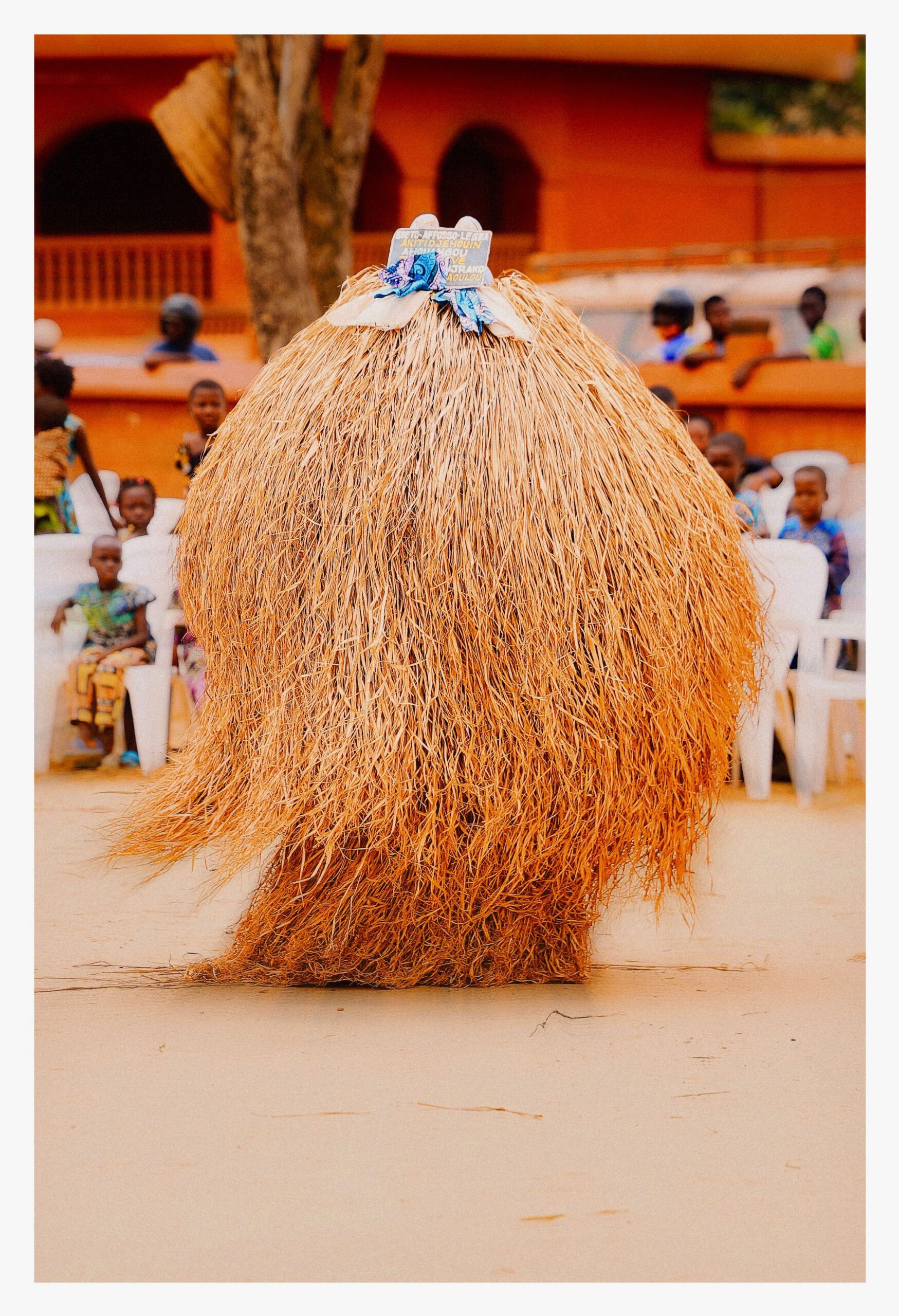 A raffia Zangbeto masquerade spinning in the square before the temple at the Festival des Masques in Porto-Novo, Benin