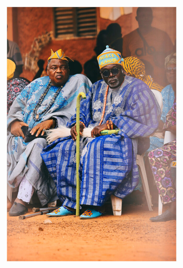 Elders in beaded regalia and coral jewellery seated as they wait for the procession