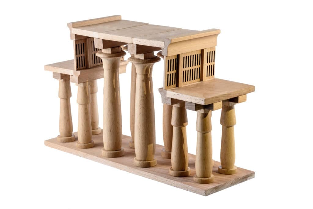 Karnak, a pale limestone and wood model of a hypostyle temple: rows of turned columns carrying flat lintels at two heights on a rectangular base.