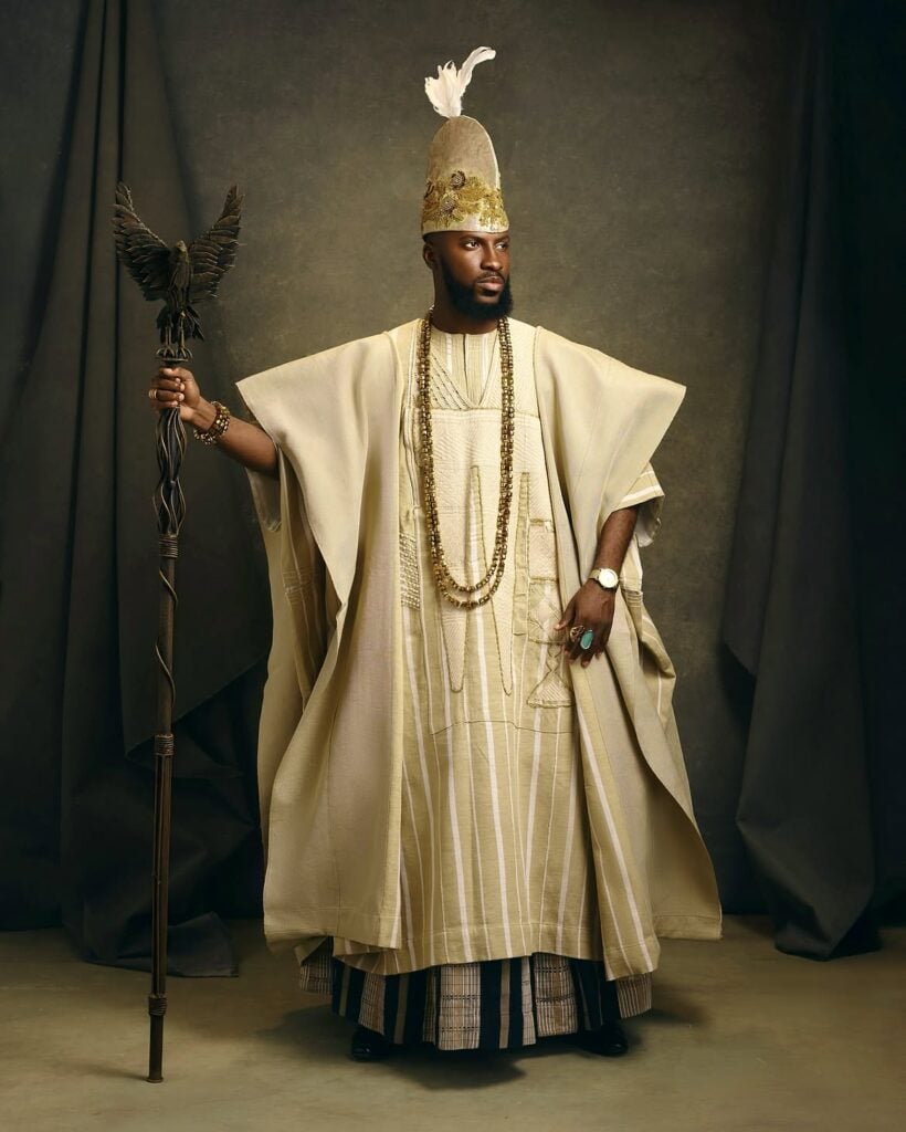 Akin Faminu on Style, Taste and the Things He Returns To 2 Akin Faminu wearing a cream Ugo Monye agbada and beaded cap while holding a staff