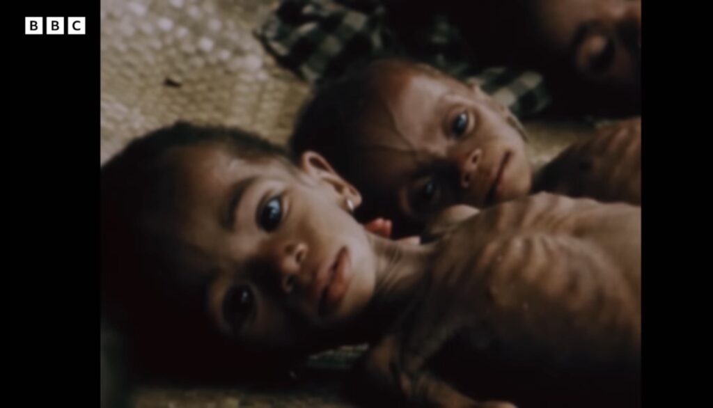 Two severely malnourished Biafran children lying side by side in BBC archive footage of the famine caused by the wartime blockade.