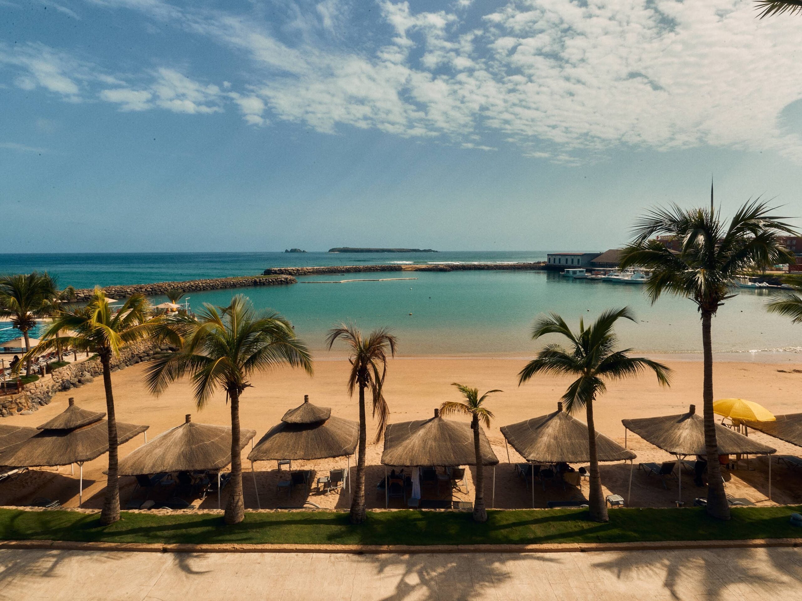 Land on the Horizon 8 The Terrou-Bi cove on the Corniche Ouest, Dakar — thatched parasols, palms and the sheltered bay