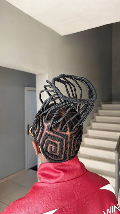 The Art of African Braiding, Through the Eyes of Gen Z 3 Rear view of Emeka Onyeziri’s geometric cornrows and tall, sculptural threaded hairstyle.