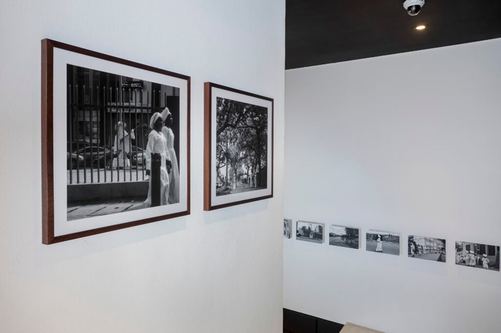 Holy Dress Codes: What Comes to Mind When You See the Garment? 6 Installation view of the exhibition at Alara Lagos, two framed street photographs beside a row of smaller prints.