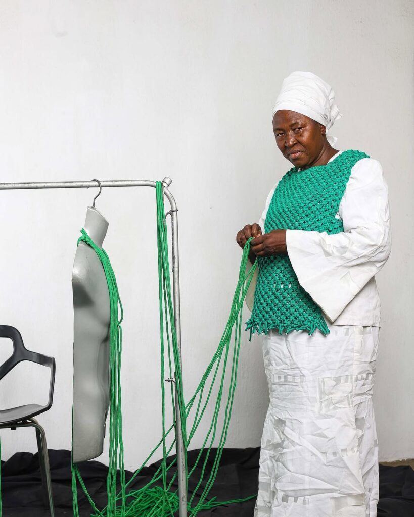 Juliet Okoruwa hand-crafting a garment using the macrame technique for GDWN