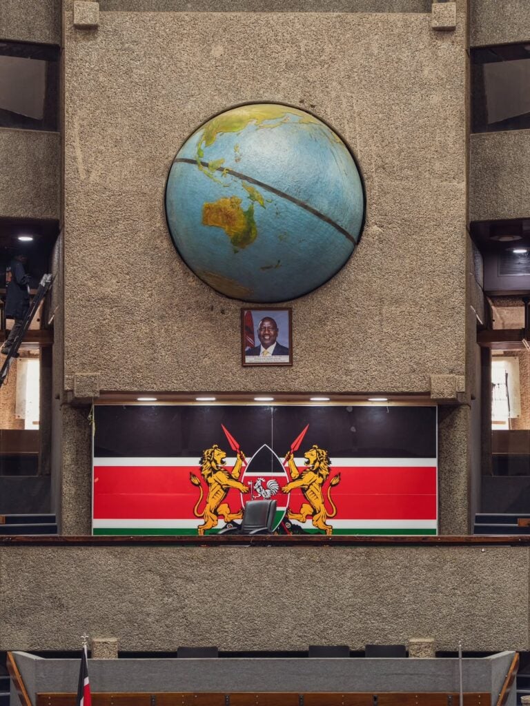 The globe and Kenyan coat of arms mounted above the dais of the KICC plenary hall