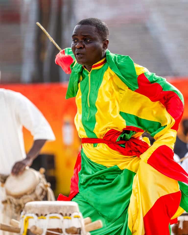 Who Made the Welcome 1 A dancer performs at a Dakar 2026 Youth Olympic Games flame-tour celebration in Senegal