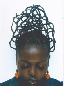 Marianne Costade wearing a tall, open lattice hairstyle made with African hair threading.