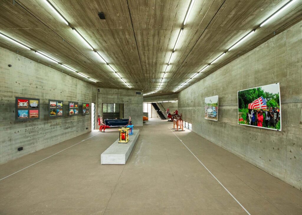 Eric Kpakpo’s Ending The Beginning exhibition, with sculptural coffins and photographs inside Nubuke Foundation’s concrete gallery in Accra, Ghana.