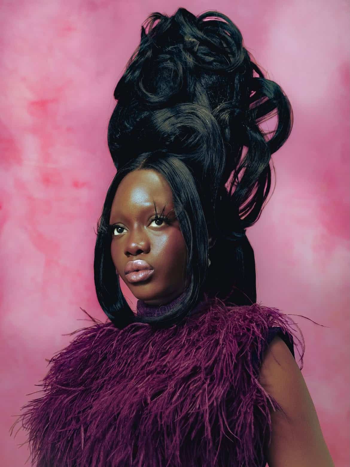 Dede Arisekola Is Building a World of Her Own 5 Holy One model in a burgundy feathered top with sculptural black hair