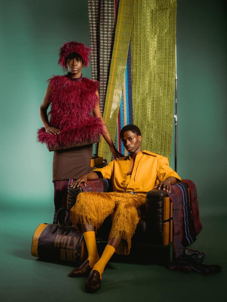 Dede Arisekola Is Building a World of Her Own 3 Holy One look by Dede Arisekola with a burgundy feathered hat and top