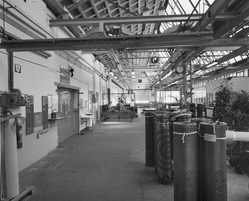 Printing rollers standing beneath the skylit roof of Vlisco’s textile factory in Helmond, the Netherlands.