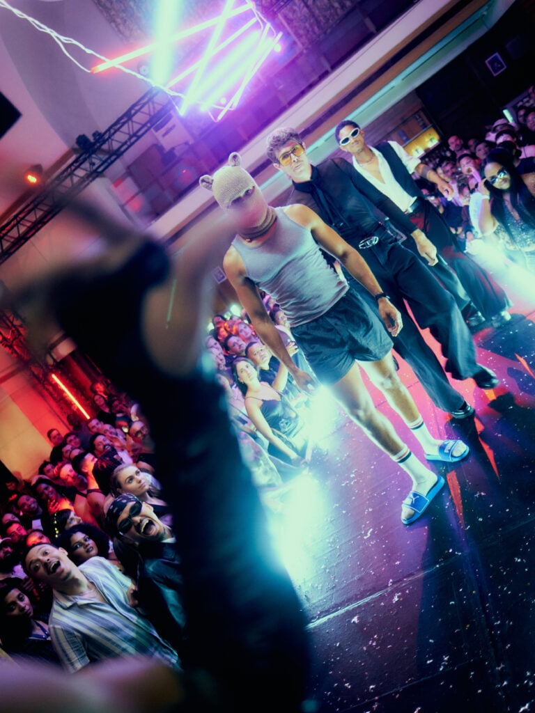 Before the House of Vlam, Cape Town’s Queer History Made Space for Ballroom 2 A performer on the dance floor at the House of Vlam After Dark Ball in Cape Town, with spectators gathered around.