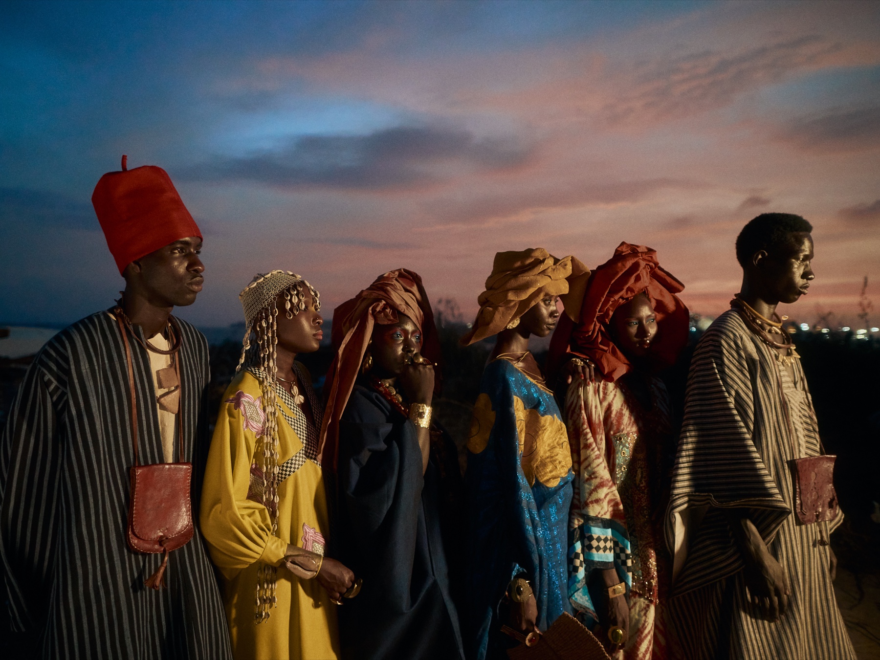 Six models in Senegalese fashion at dusk, from The Ritual of Attaya cover shoot.